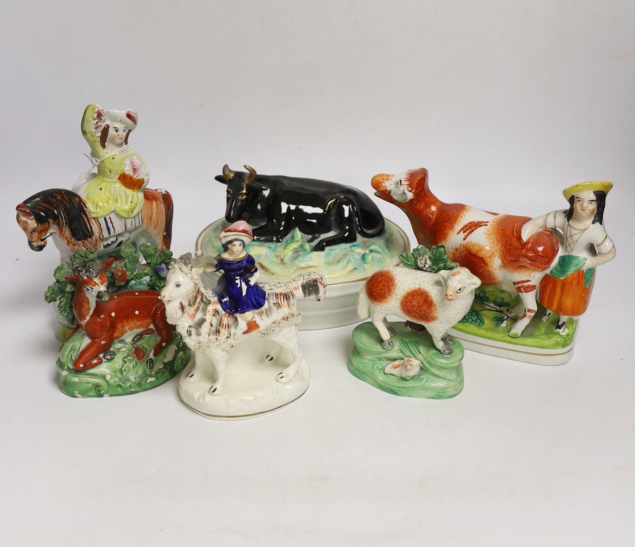 A Victorian Staffordshire cow tureen and cover, and five other Staffordshire figures, largest 18cm wide